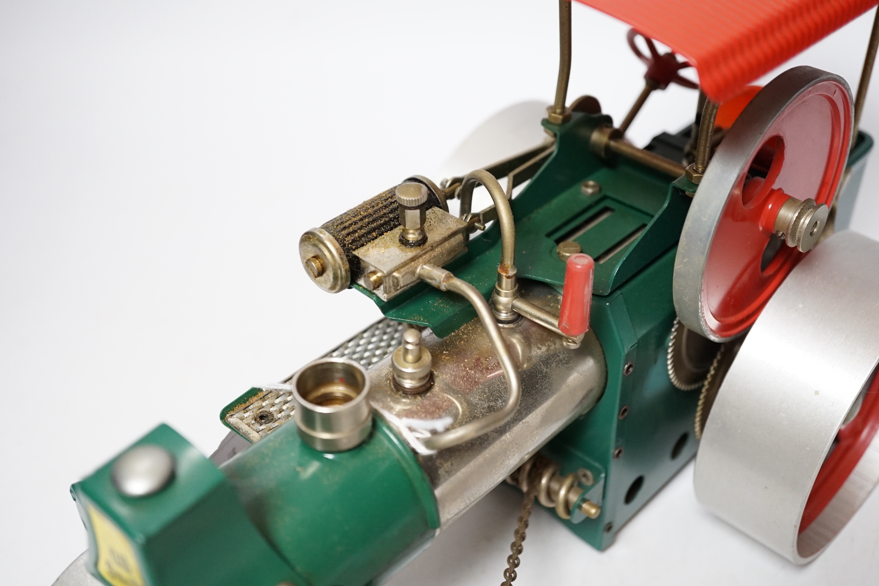 A Wilesco live steam tinplate and aluminium model Road Roller, missing its chimney